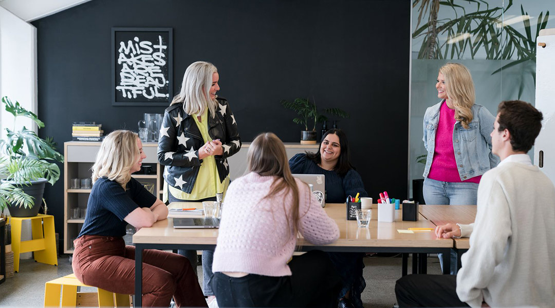 Excellent.io employees around a conference table